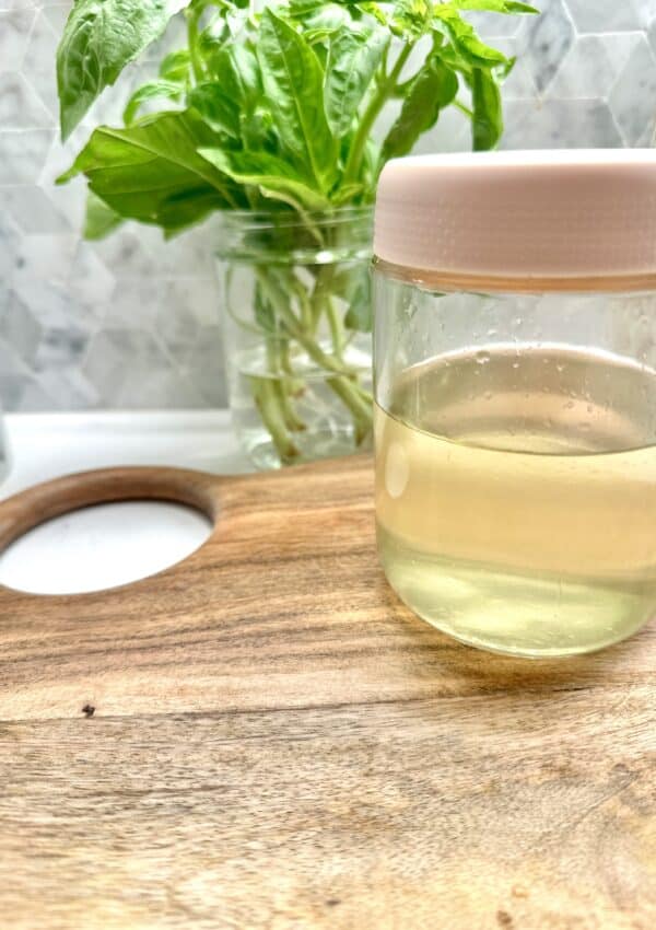 Citrus simple syrup in a glass on cutting board