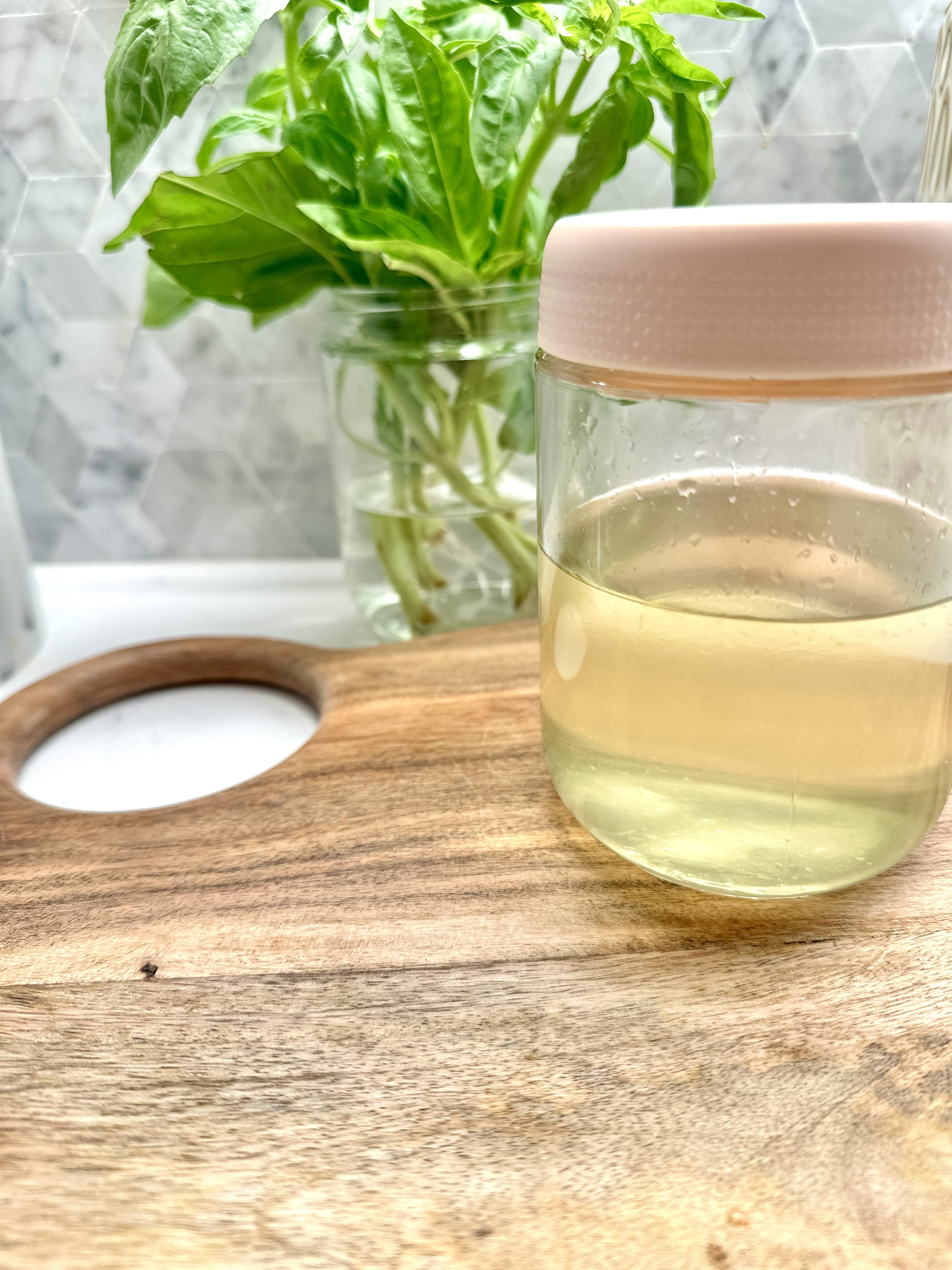 Citrus simple syrup in a glass on cutting board
