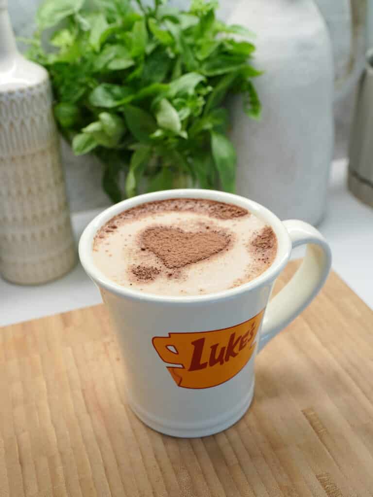 Pumpkin Spice Latte in a mug with heart shaped topping