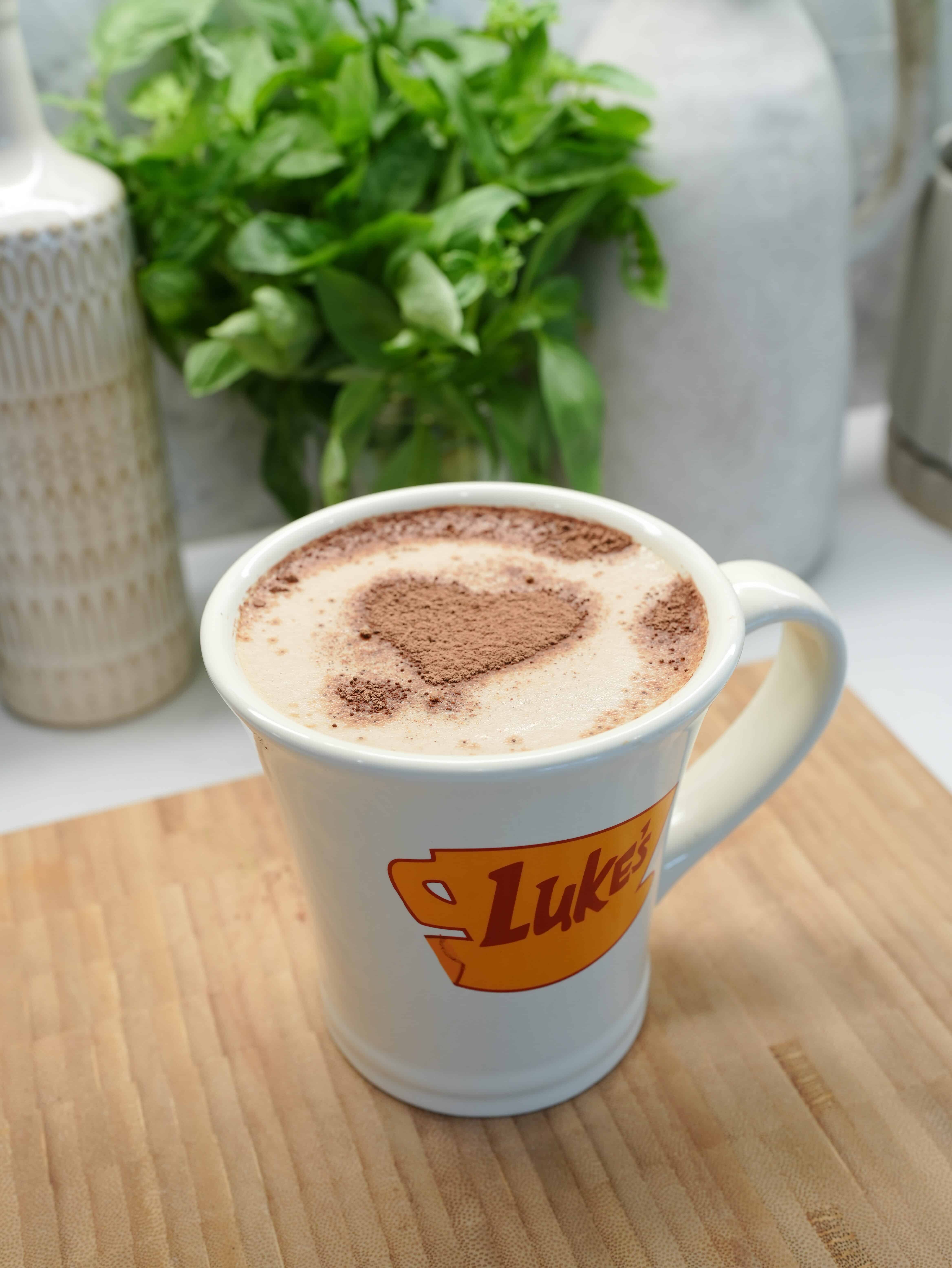 Pumpkin Spice Latte in a mug with heart shaped topping